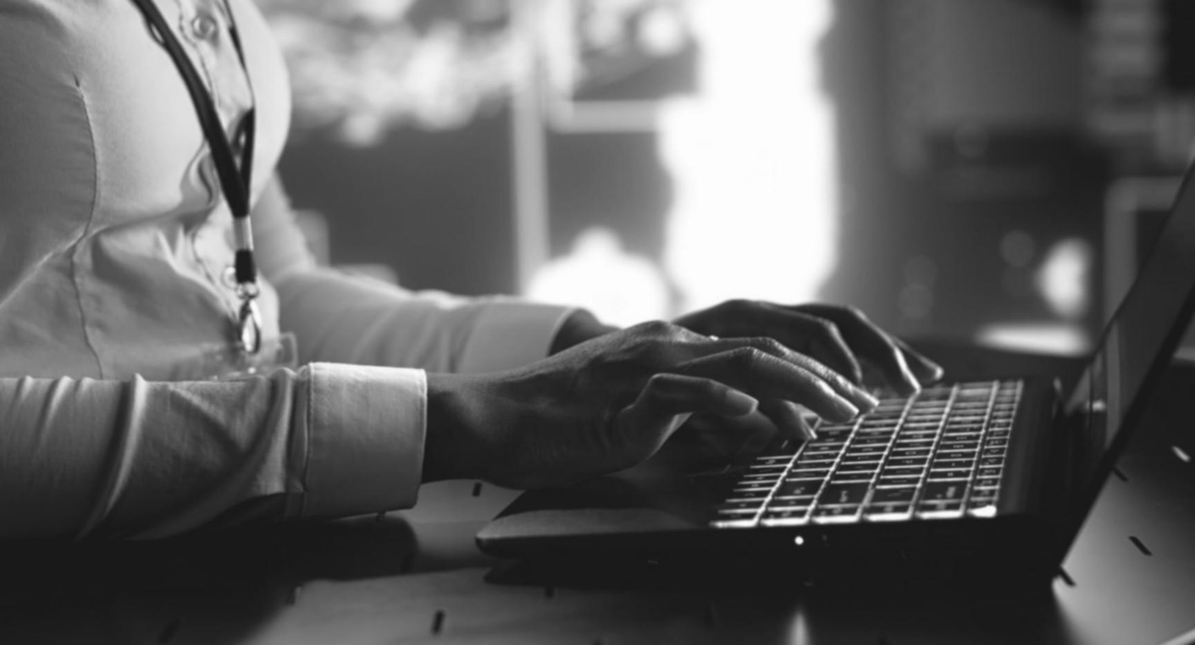 Students working on virtualization lab exercises with multiple monitors showing container orchestration